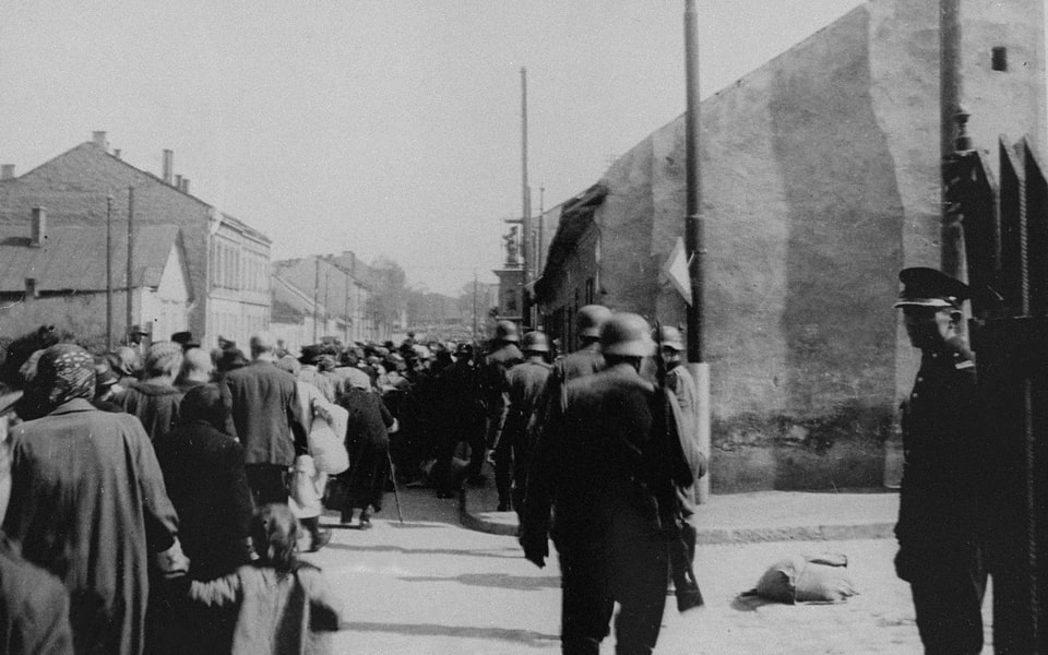 A column of Jews marches through the streets of Krakow during the final liquidation of the ghetto 1943
