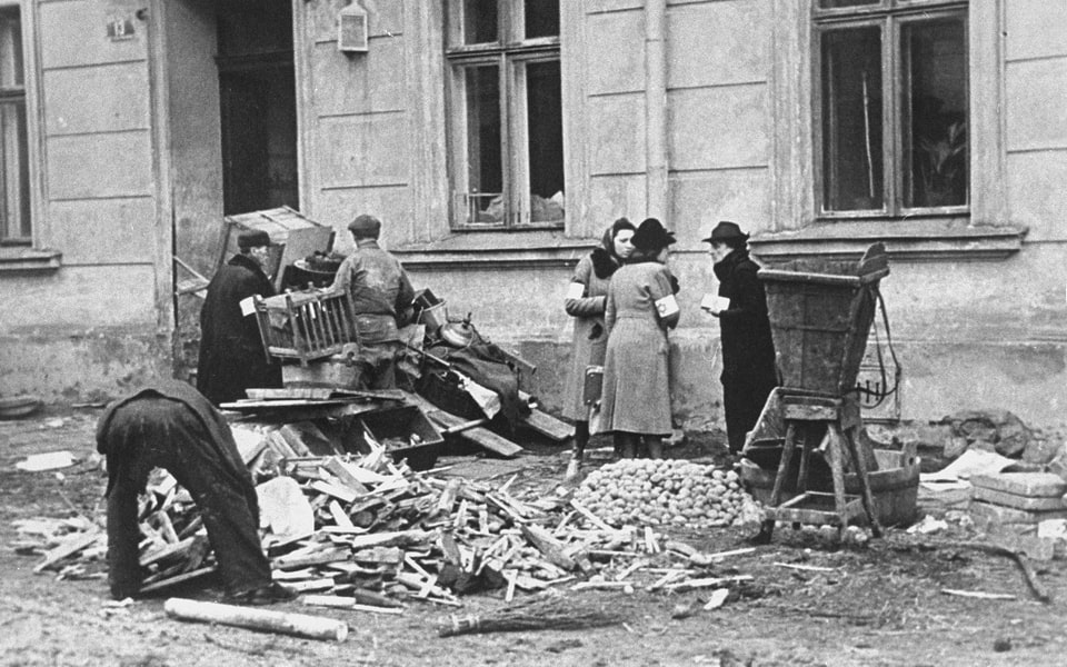 A group of Jews chop up furniture to use as fuel in the Krakow ghetto