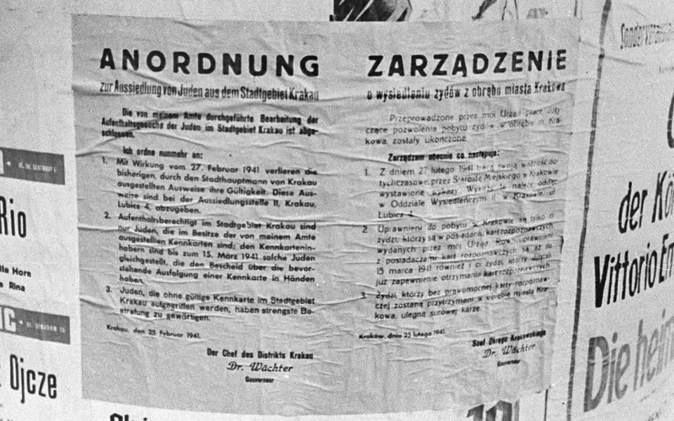 Close-up of an announcement affixed to a city kiosk, ordering the resettlement of Jews from the city of Krakow, signed by district chief, Dr. Wachter