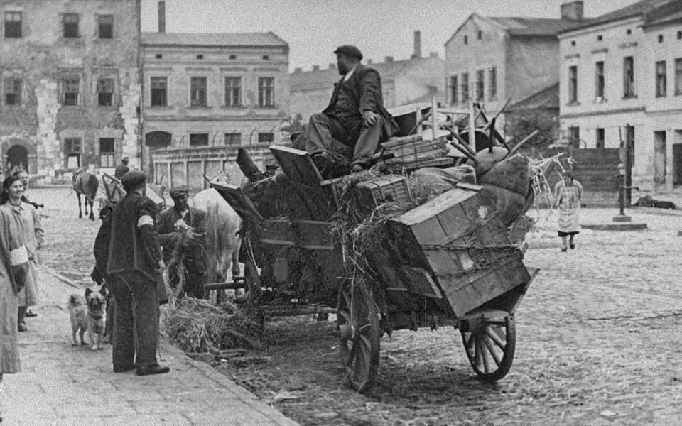 Forced to relocate to the Krakow ghetto, Jews move their belongings in horse-drawn wagons_