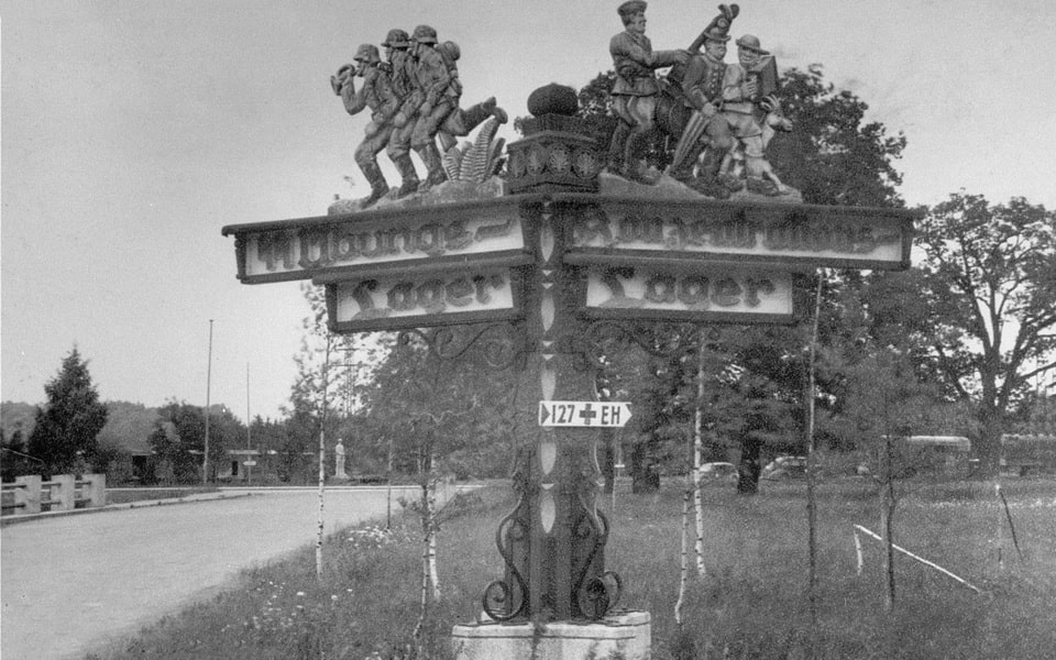 Road sign pointing to the Dachau concentration camp and SS training facility at the entrance to Nibelungenstraße — the Line of Death route
