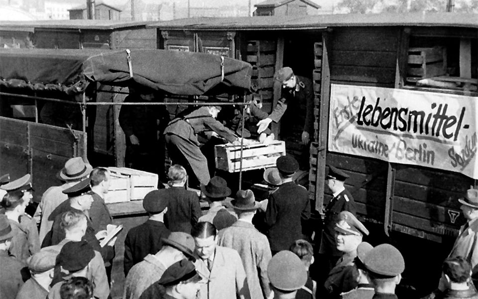 German soldiers unloading the first batch of agricultural products shipped from occupied Ukraine to Berlin, 1942 — part of the systematic economic exploitation of Reichskommissariat Ukraine