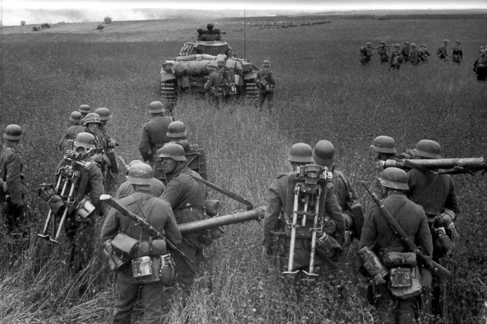 German infantry advancing under cover of tanks in the field during Operation Barbarossa
