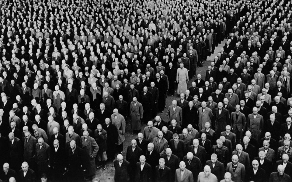 Newly arrived Jewish prisoners stand at attention in their civilian clothes during the roll call at Buchenwald, November 1938