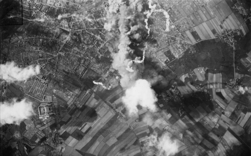 AERIAL PHOTOGRAPH OF SMOKE PLUMES RISING FROM AERIAL BOMBING OF FRANKFURT, GERMANY