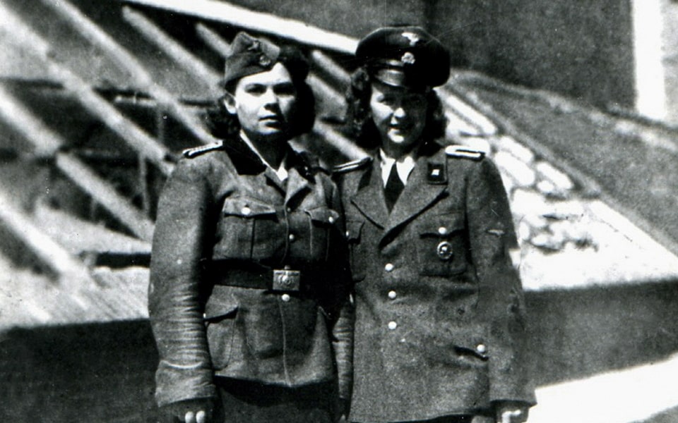 German guards - Krysta Golos and Eugenia Szczerbińska against the background of the greenhouse of the women_s prison. The first of them,received a death sentence in 1944, but escaped justice.