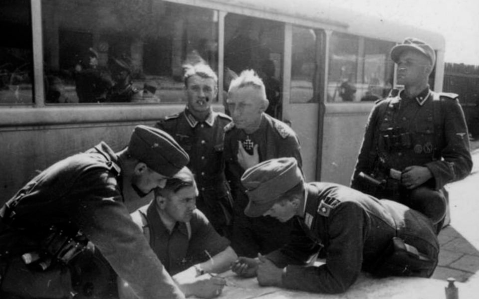 Heinz Reinefarth (middle of photo) at his command post in Warsaw in August 1944. In two days from 5 August the units of Reinefarth and Dirlewanger murdered tens of thousands of civilians in the ‘Wola