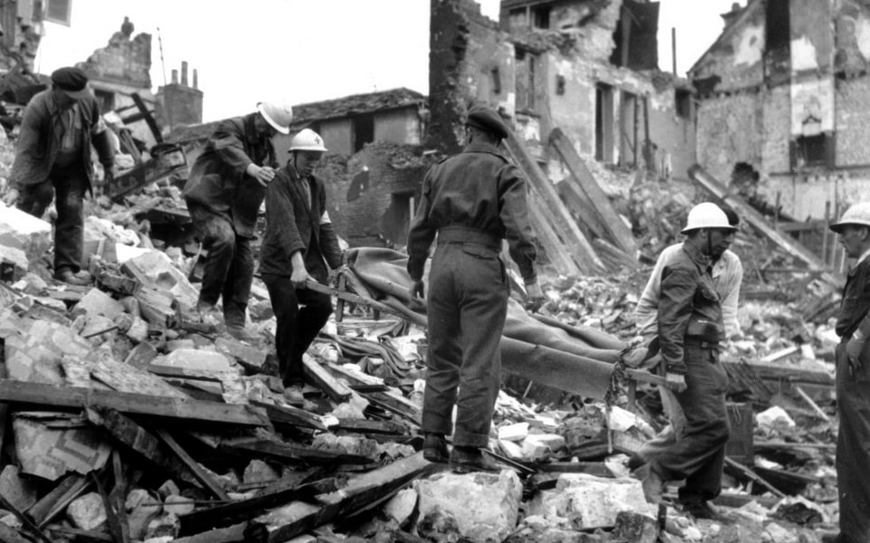 July 9, 1944 Volunteers pull a victim from the ruins of Caen