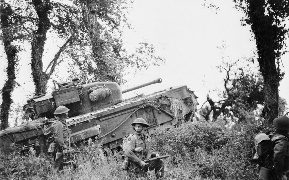 British soldiers (8th Royal Scots) under cover of a Churchill tank from the 7th Tank Regiment, 31st Tank Brigade (7th Royal Tank Regiment, 31st Tank Brigade)