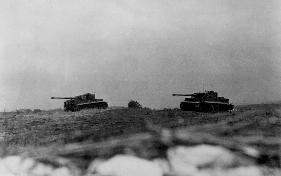Two German Pz.Kpfw. VI Tiger tanks in a field south of Caen
