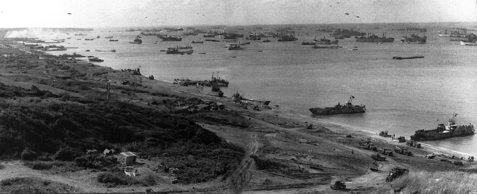 The logistic build-up begins. Note the horseshoe shape of Omaha Beach. This was a defender’s dream