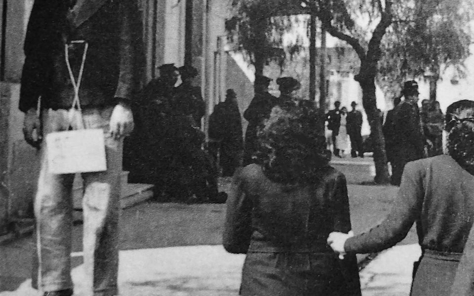Residents of a town in occupied Greece walk past a hanged young man 1943-1944