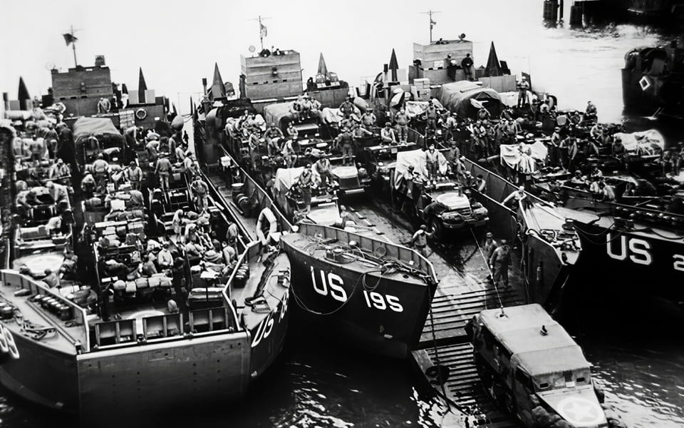 AAmerican soldiers preparing to board landing craft for Normandy, June 5 1944 — night before D-Day embarkation
