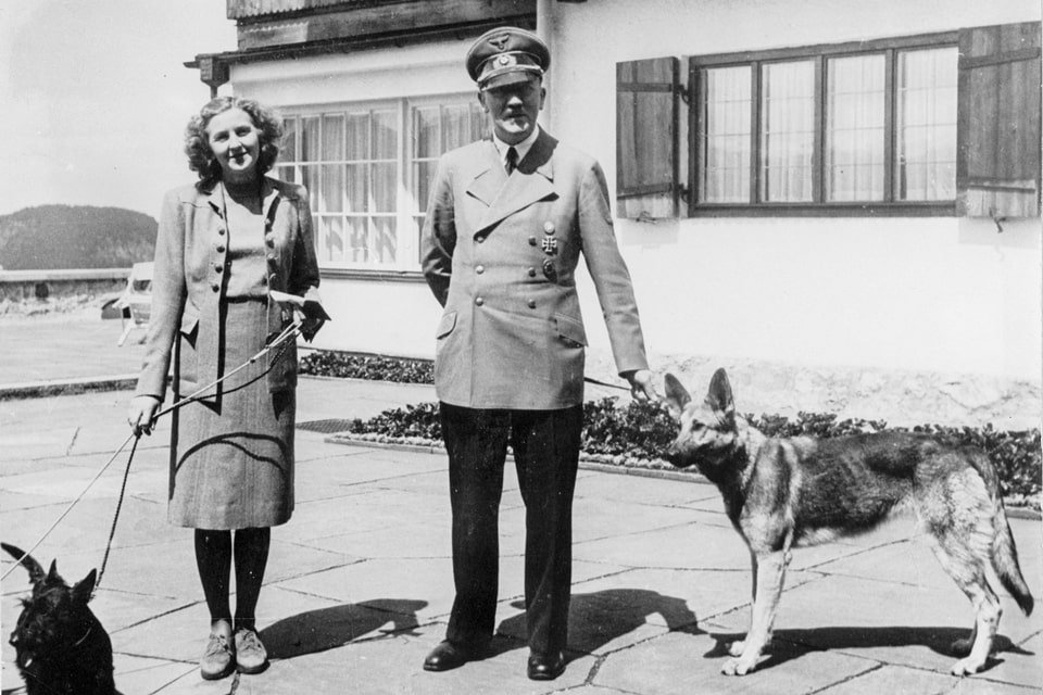 Eva Braun and Hitler pose with their beloved dogs on the Berghof terrace