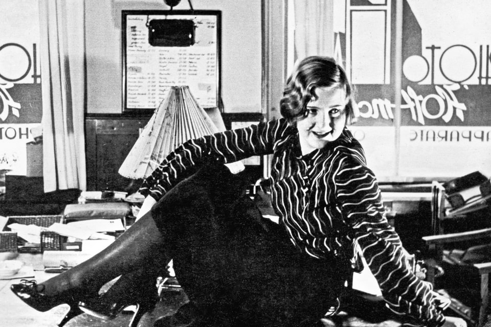 Eva Braun posing on a desk in Heinrich Hoffmann’s atelier in the office at Amalienstrasse in 1930