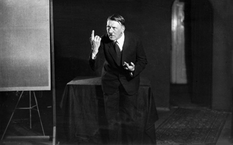 Adolf Hitler rehearsing his oratory in a mirror in 1925. Captured by his photographer Heinrich Hoffmann