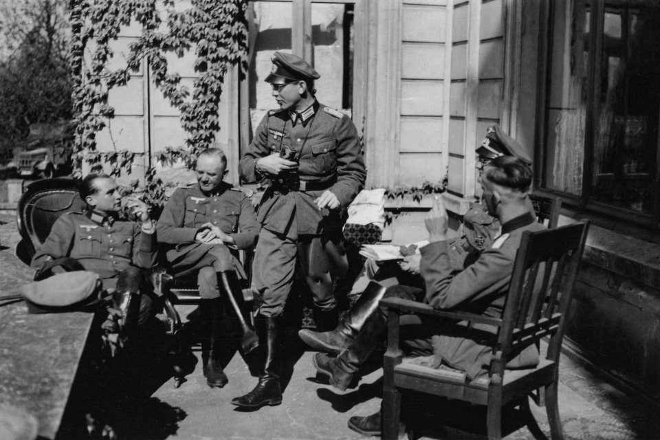 German soldiers relaxes outside a home in Paris