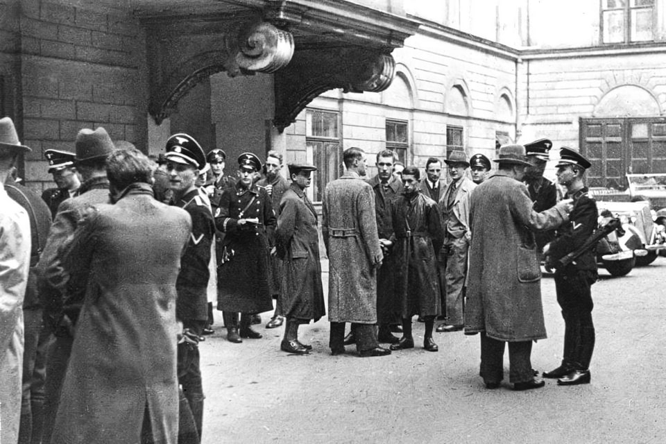 Police and SS, including Adolf Eichmann, gather in a courtyard before the start of the round-up of the Jewish community in Vienna on March 18, 1938