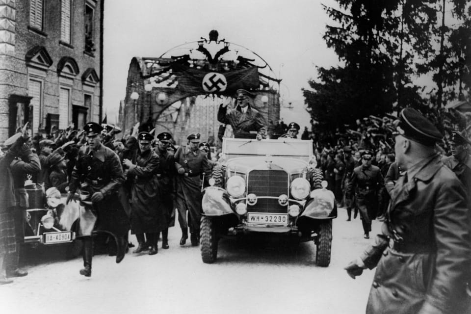 Adolf Hitler drives through his hometown Braunau on the afternoon of the Anschluss Day