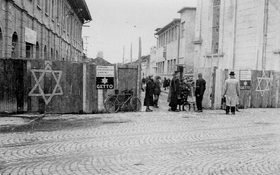 A Hungarian gendarme checks a woman entering the Munkács ghetto