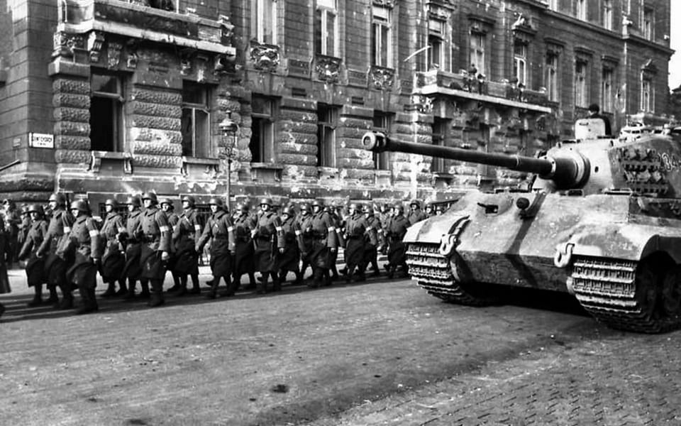 A German Tiger II with a column of Arrow Cross soldiers in Budapest