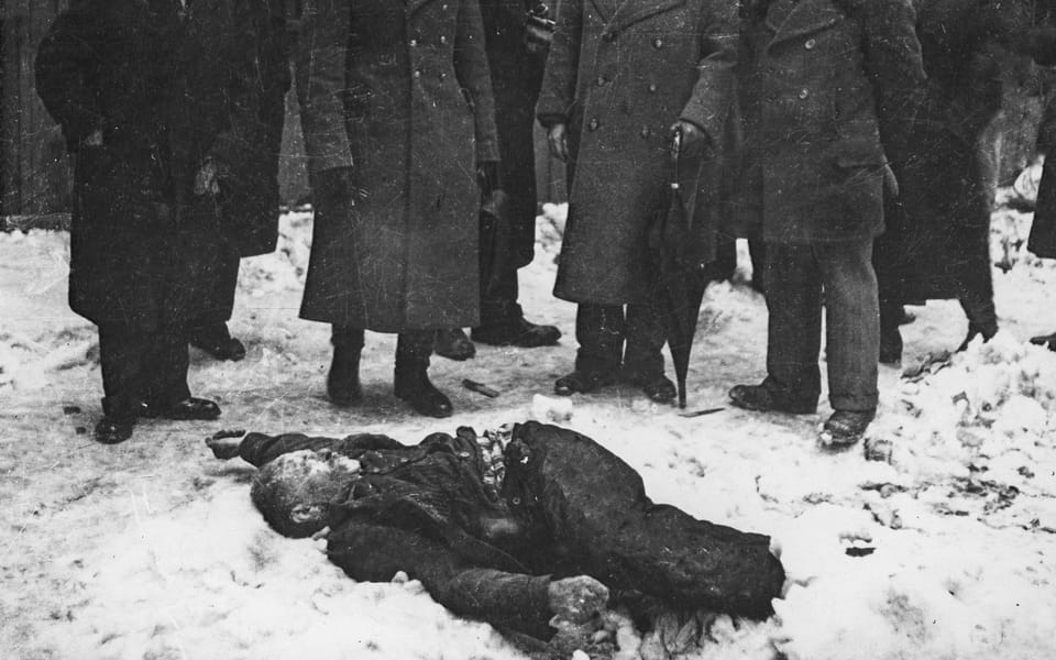 Members of the Commission for the Investigation of Nazi and Arrow Cross Atrocities examine the body of a Jewish man
