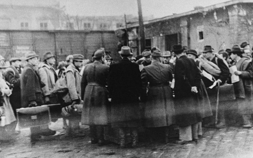 Raoul Wallenberg is present at the Jozsefvaros train station in Budapest where Jews who have been rounded-up for deportation, wait on the platform-
