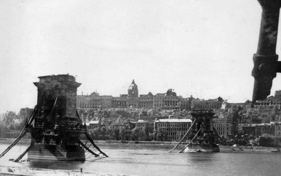 the destroyed Széchenyi Chain Bridge and the ruined Royal Palace (later Buda Castle Palace) seen from Széchenyi István (Ferenc József) Square 1945